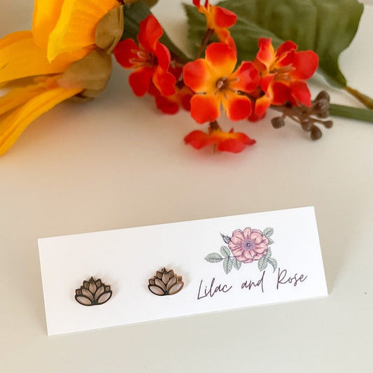 Rose gold lotus flower stud earrings on display card