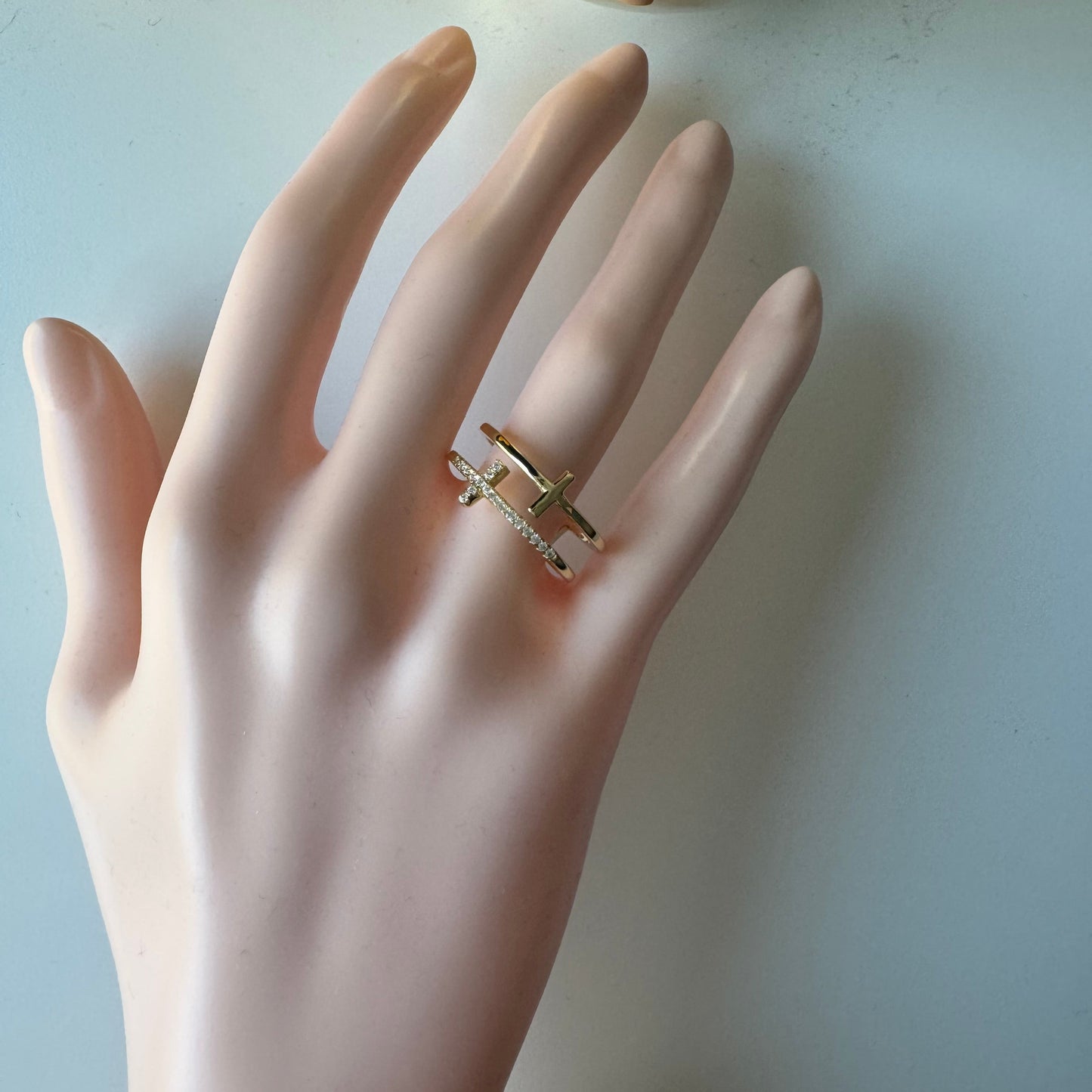 Mannequin hand wearing a silver ring on a light background