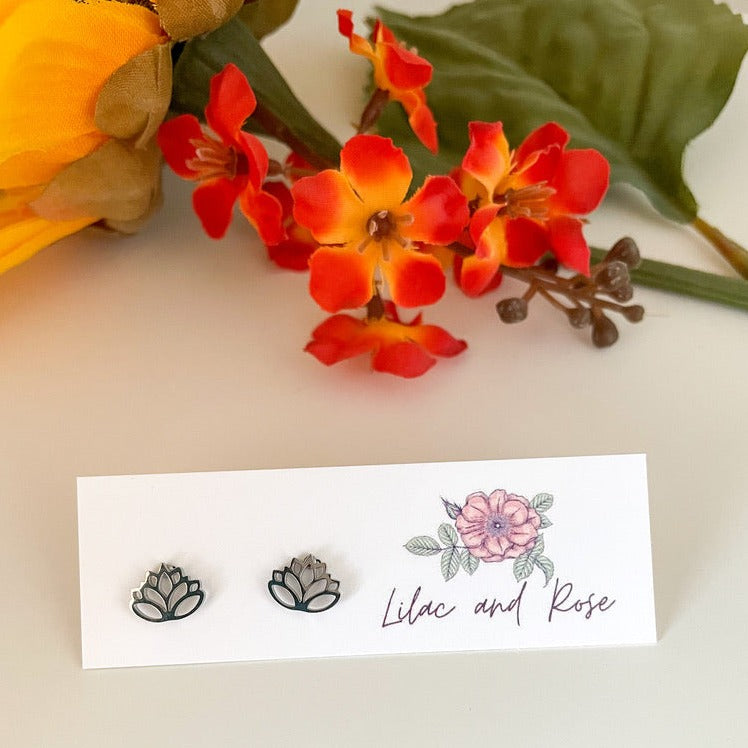 Silver lotus flower stud earrings on display card