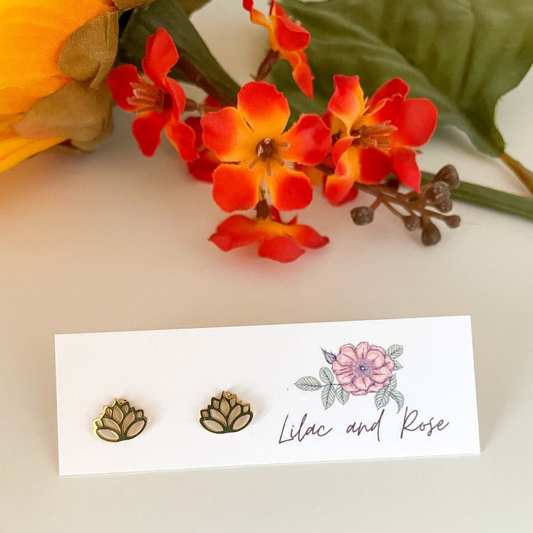 Gold lotus flower stud earrings on display card