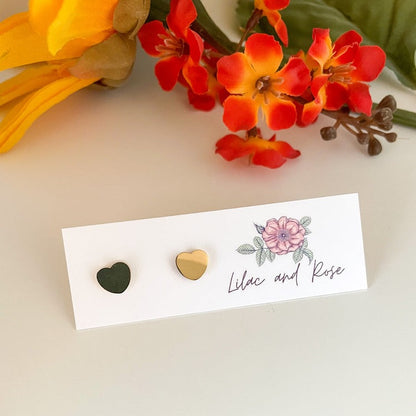 Gold heart stud earrings on display card