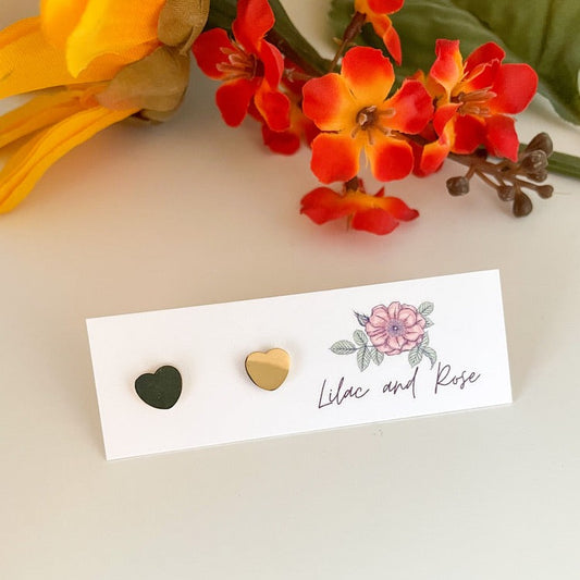 Gold heart stud earrings on display card