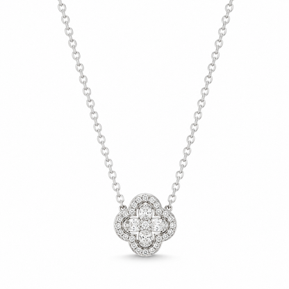 A silver-toned diamond necklace featuring a clover-shaped pendant with a central round diamond surrounded by a halo of smaller diamonds, suspended from a delicate cable chain against a white background.