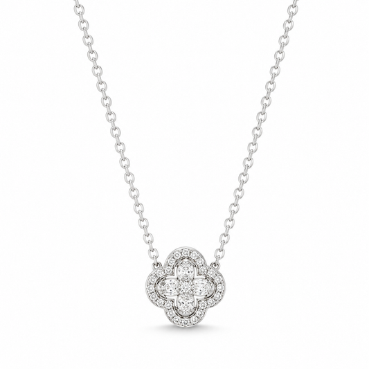 A silver-toned diamond necklace featuring a clover-shaped pendant with a central round diamond surrounded by a halo of smaller diamonds, suspended from a delicate cable chain against a white background.