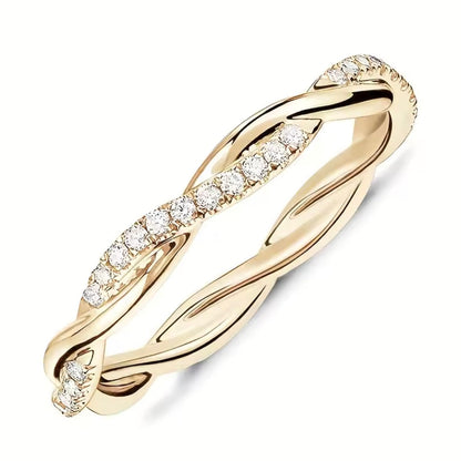 Gold ring with diamond accents on a white background
