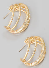 Load image into Gallery viewer, Gold hoop earrings on a light gray background
