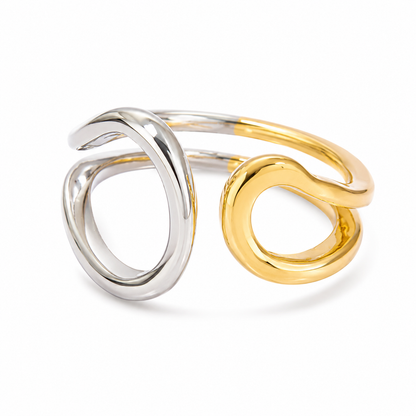 An open wrap ring featuring two intertwined loops, one polished silver-tone and one polished gold-tone, set against a clean white background.