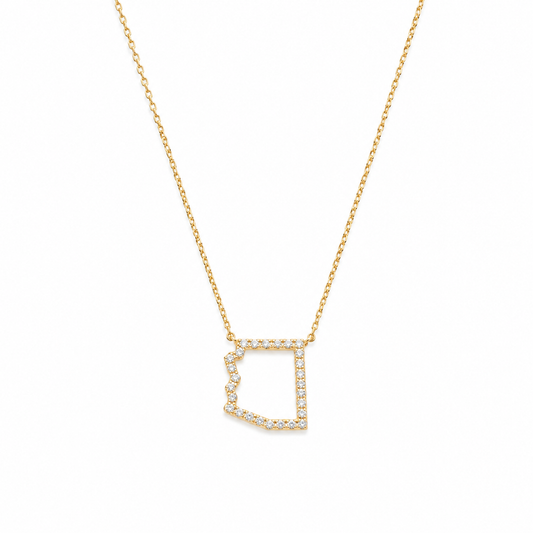 A gold chain necklace featuring an Arizona pendant outlined with small clear stones, shown against a plain white background.