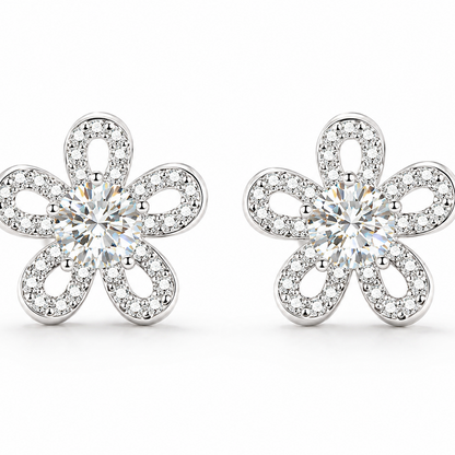 A pair of silver flower-shaped stud earrings set with clear round-cut and pave moissanite, shown on a clean white background.
