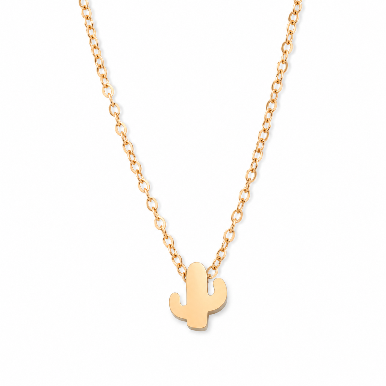 A delicate gold chain necklace featuring a small, minimalist cactus pendant, shown against a solid white background.