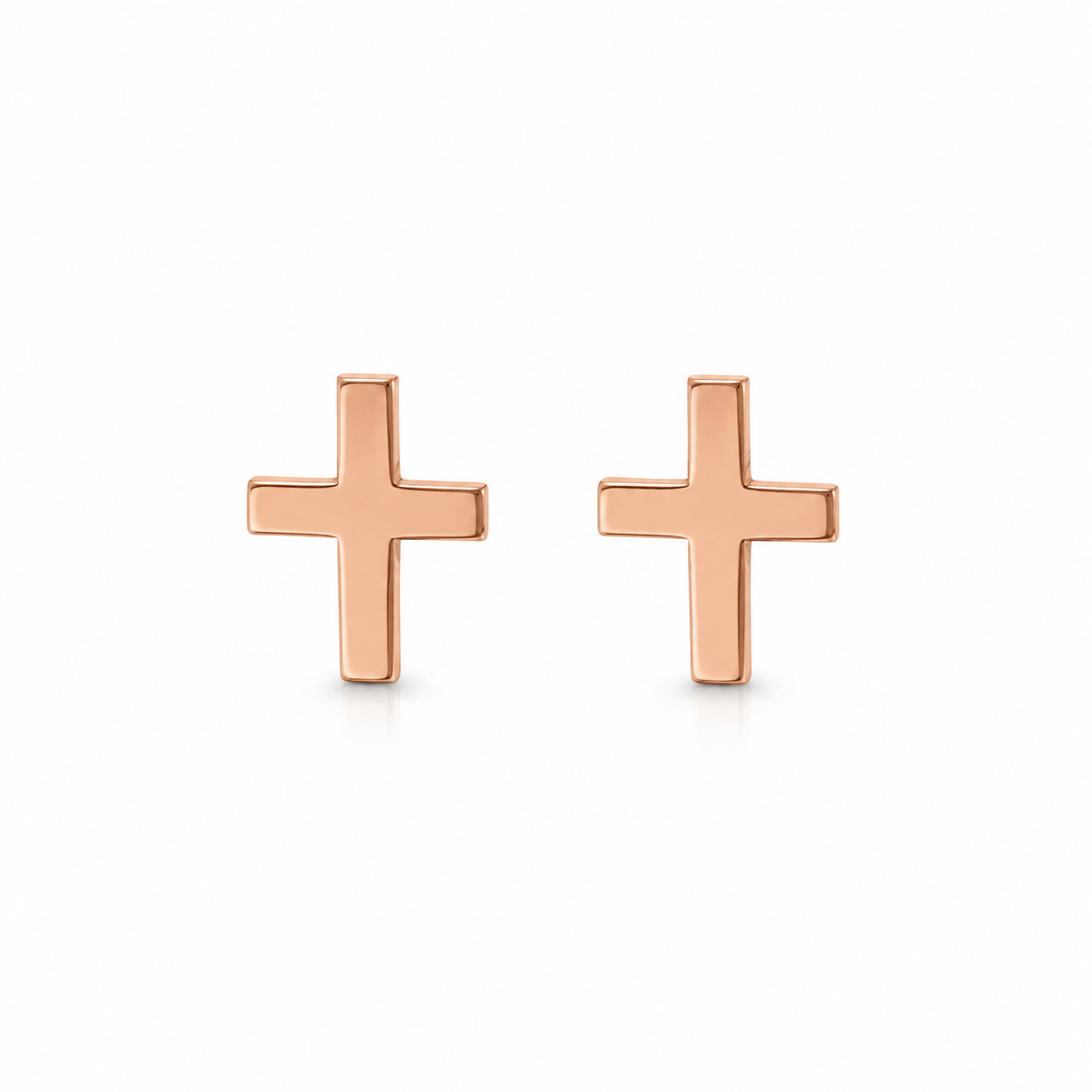 A pair of minimalist rose gold cross stud earrings on a clean white background.