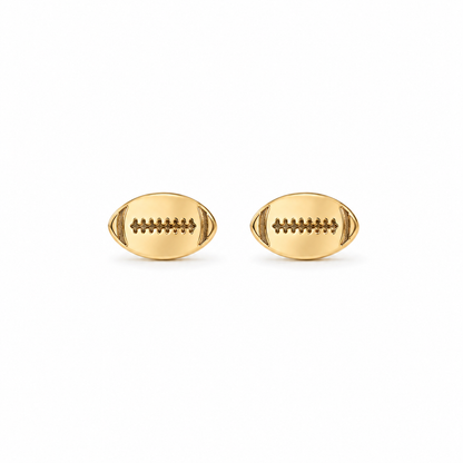 A pair of gold football stud earrings with detailed lacing, shown on a plain white background.