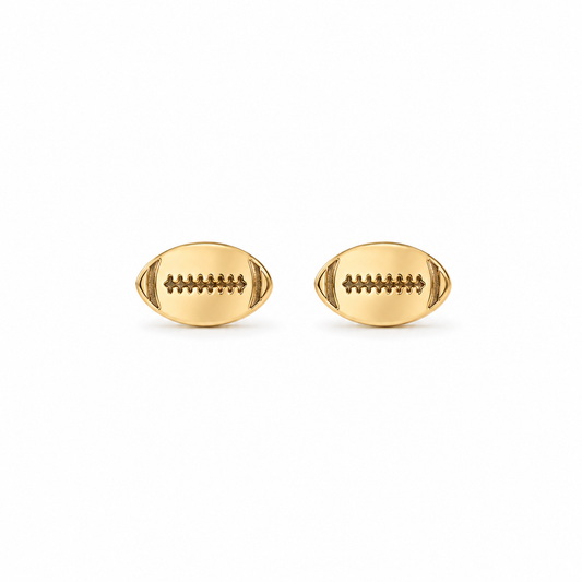 A pair of gold football stud earrings with detailed lacing, shown on a plain white background.
