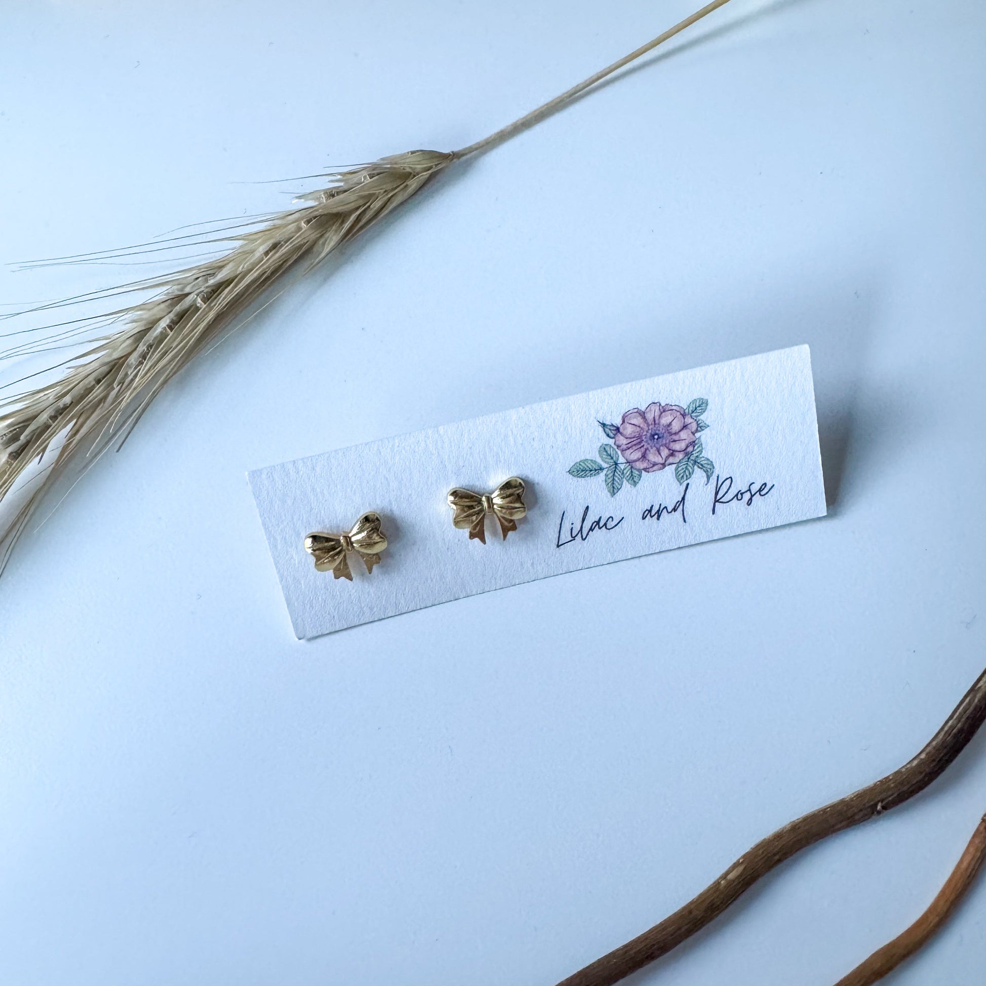 polished gold bow studs lightweight hypoallergenic jewelry