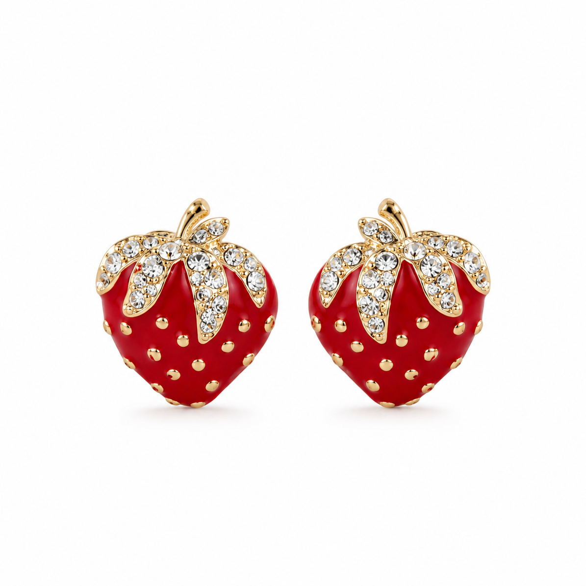 A pair of strawberry-shaped stud earrings with glossy red enamel bodies, gold-tone stems and dotted details, and clear rhinestone-encrusted leaves, shown on a plain white background.