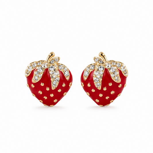 A pair of strawberry-shaped stud earrings with glossy red enamel bodies, gold-tone stems and dotted details, and clear rhinestone-encrusted leaves, shown on a plain white background.